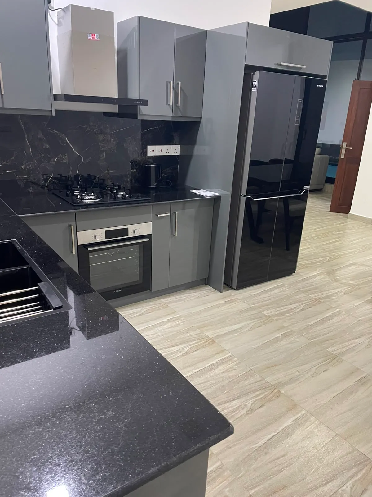 Modern kitchen with six-seater dining table at TenTwo private villa Kandy